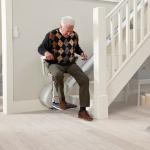 What are the benefits of installing a stair lift at home or in a public place?