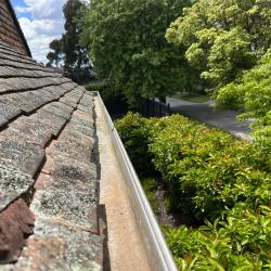 View Photo: Gutter Cleaning on an old terracotta shingle roof