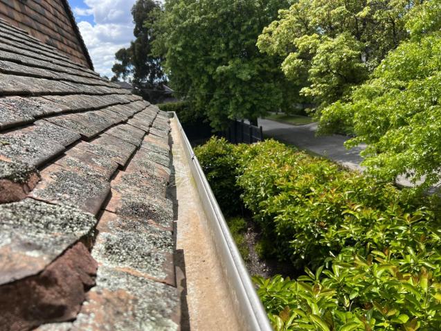 View Photo: Gutter Cleaning on an old terracotta shingle roof