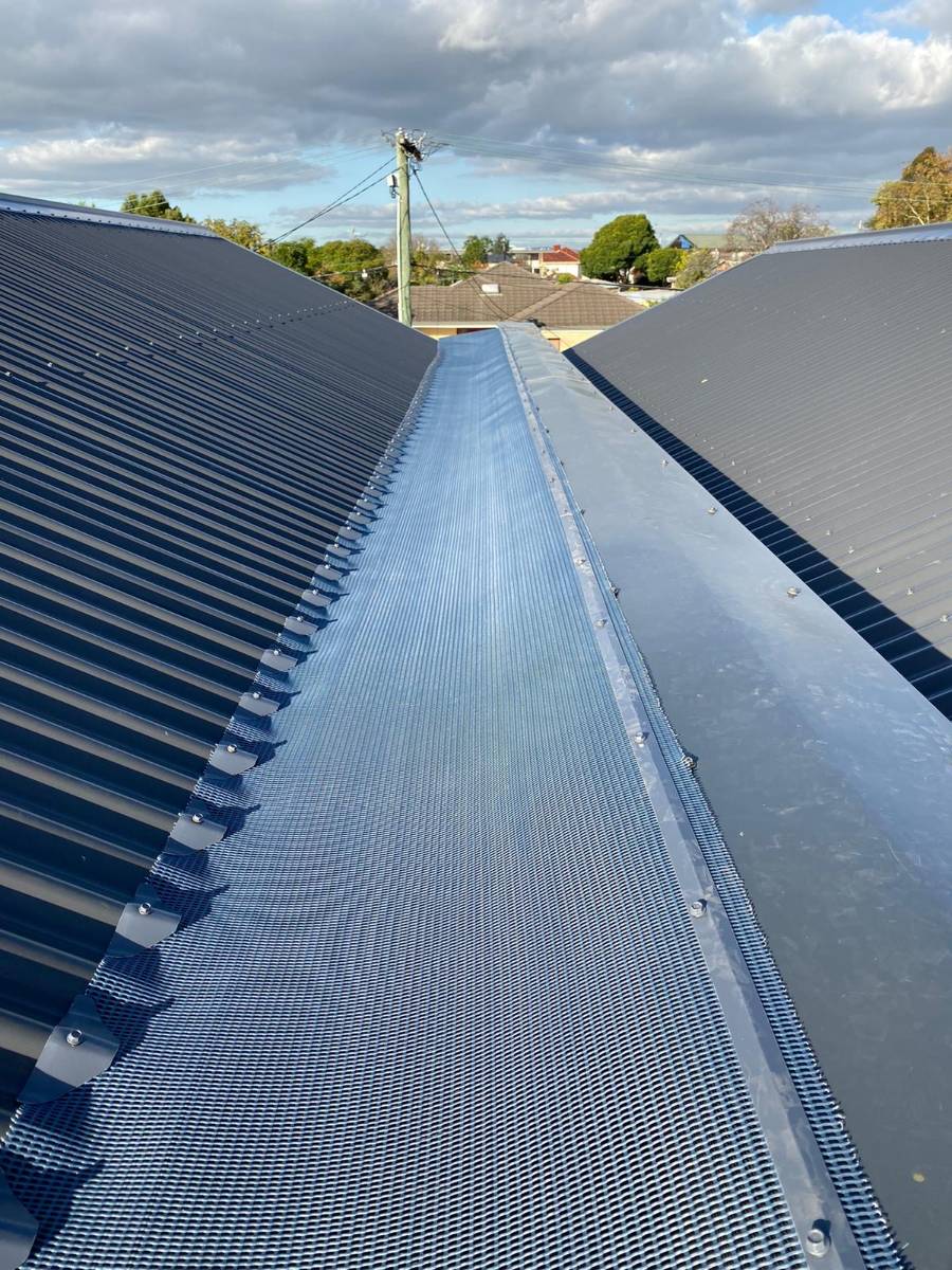 Gutter guard mesh on a central roof channel