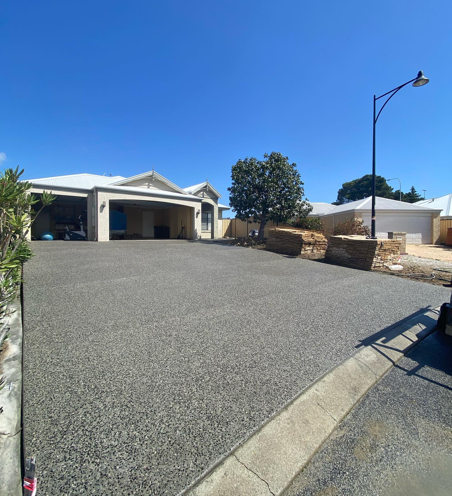 Three Car Wide Driveway with Exposed Aggregate Concrete Finish