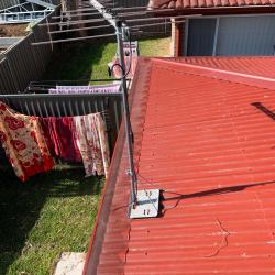 View Photo: Manor Red metal gutter guard on corrugated roofs