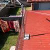 Manor Red metal gutter guard on corrugated roofs