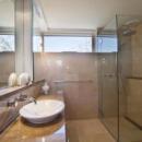 View Photo: Bathroom Space Enhanced with Consistent Colour