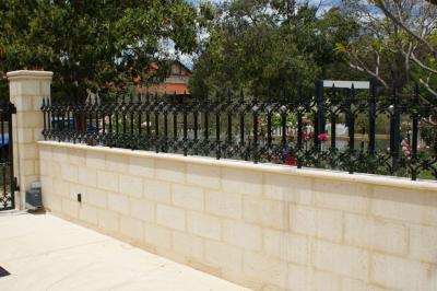 Limestone Wall and Low, Decorative Wrought-Iron Fence